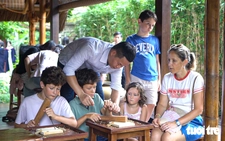 Foreign tourists try carpentry at Temple of Literature in Hanoi