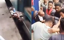 Người cha dũng cảm lao xuống đường ray cứu con thoát chết trong gang tấc khi đoàn tàu chạy qua