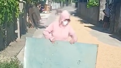 Clip người phụ nữ mang tôn, gỗ chặn đường ô tô để phơi lúa