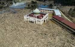 Nowhere to pray as logs choke flood-hit Indonesian mosque