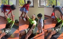Ronaldo vừa gập bụng vừa một tay nâng con gái
