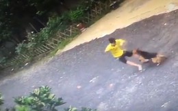 Thanh niên ngồi buồn ở vỉa hè bị chó rượt