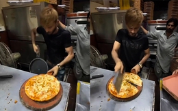 Chàng trai tay nhanh hơn não khi cắt bánh pizza