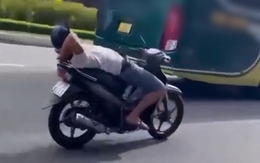 Người đàn ông thả 2 tay, nằm ngửa trên xe máy chạy qua cầu Rồng là ai?