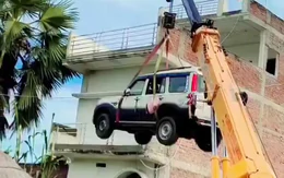 Sợ ô tô mới mua bị trộm, chủ xe thuê cần cẩu đưa lên nóc nhà