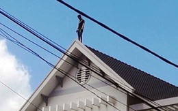 Hàng chục cảnh sát giải cứu thanh niên 'làm xiếc' trên mái nhà