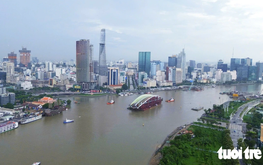 Barge carrying 3,400-tonne pedestrian bridge arch arrives in downtown Ho Chi Minh City