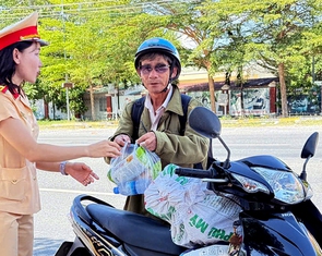 Cảnh sát giao thông phát nước, bánh, sữa cho người dân về quê nghỉ lễ