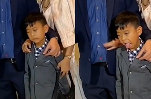 Bé trai tấu hài khi cùng bố mẹ chụp hình với cô dâu chú rể