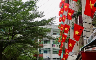Vietnamese flags adorn apartment balconies across Ho Chi Minh City for Reunification Day