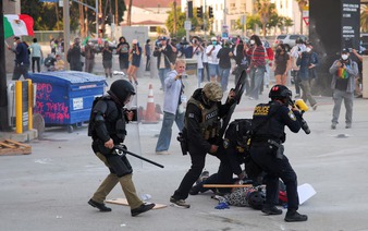 Riot police, anti-ICE protesters square off in Los Angeles after raids