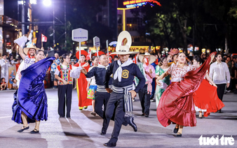 Vietnamese, foreigners in traditional costumes bring Hanoi streets to life