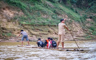 Students brave dangerous bamboo raft rides to school in Vietnam as authorities seek funds for safer crossing
