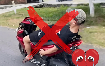 Da Nang teenager summoned for riding motorcycle hands-free while lying on seat