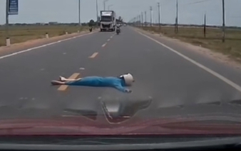 Vietnam police investigate viral clip of woman lying on road to block car