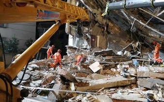 China hotel collapse kills eight; rescuers search for nine missing