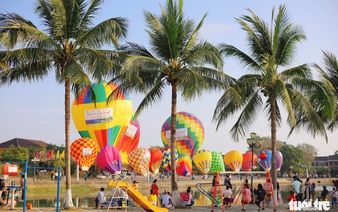 Hot-air balloons illuminate the sky above Hoi An's tourism festival