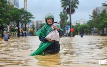 Vietnam's Hue residents struggle through floodwaters as city remains submerged