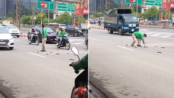 Người đàn ông chạy xe ôm công nghệ cặm cụi nhặt từng viên gạch rơi giữa đường vào vỉa hè