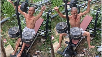 Người đàn ông đu tạ khi tập gym