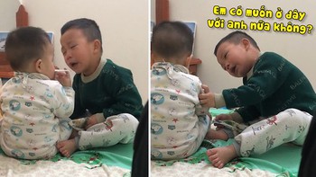 Bé trai mếu máo dỗ dành em ở lại với mình