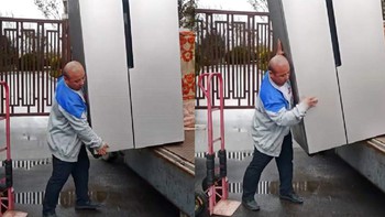 Người đàn ông một mình cân cả cái tủ lạnh to xuống thùng xe tải