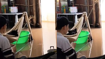 Chàng trai ngồi trong nhà câu cá, kiếm ít đồ ăn chiều mùa nước nổi