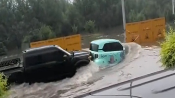 Ô tô xăng và ô tô điện dìu dắt nhau qua đường ngập