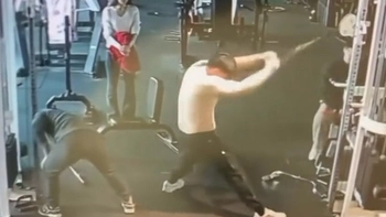 Hai thanh niên đọ sức kéo tạ trước người đẹp