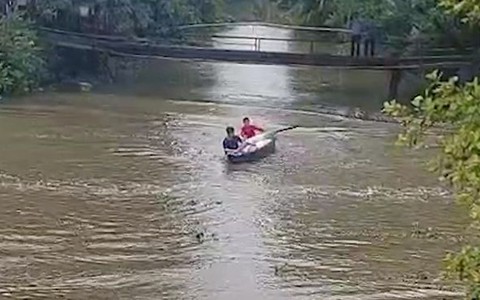 2 chàng trai chèo thuyền bị sóng xuồng máy đánh ngã xuống sông
