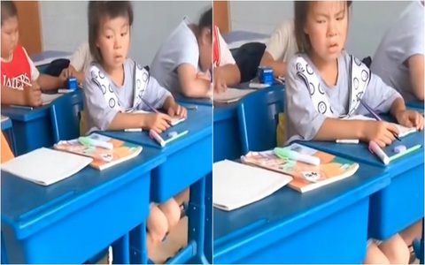 Bé gái nhíu mày khi nhìn trộm bài kiểm tra