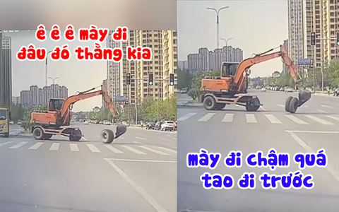Máy xúc đang sang đường thì rơi bánh