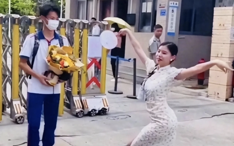 Mẹ múa quạt trước cổng trường mừng con trai vừa thi xong