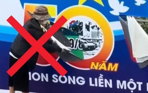 Công an xác minh người phụ nữ ở Hà Nội cầm dao rạch biển pa nô chào mừng ngày thống nhất đất nước