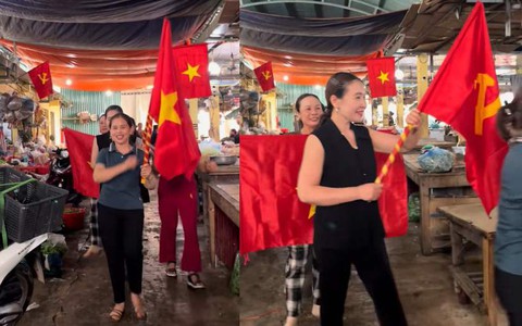 Bà con tiểu thương Nghệ An cầm cờ diễu hành quanh chợ mừng lễ 30-4