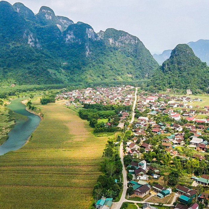 A view across Tan Hoa village in its green limestone valley