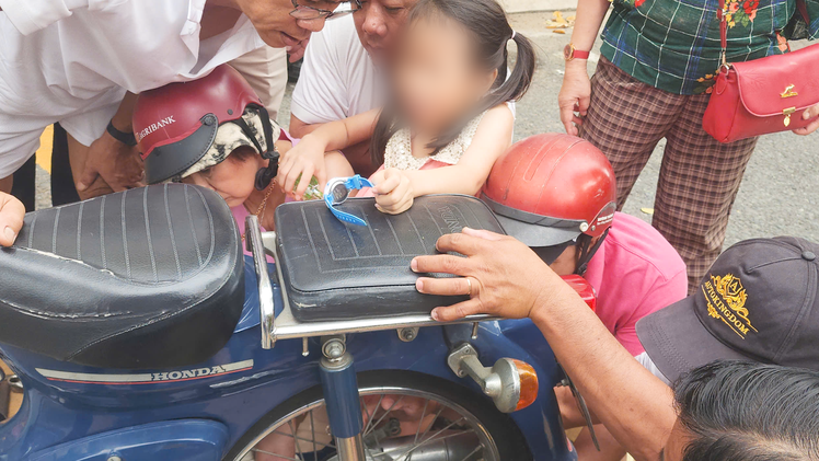 Nghe bé gái kêu cứu, người đi đường chạy đến giải cứu chân cháu bị kẹt vào căm xe