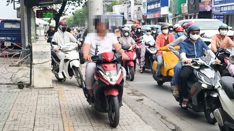 Người đi xe máy vẫn 'rồng rắn' leo vỉa hè ở TP.HCM