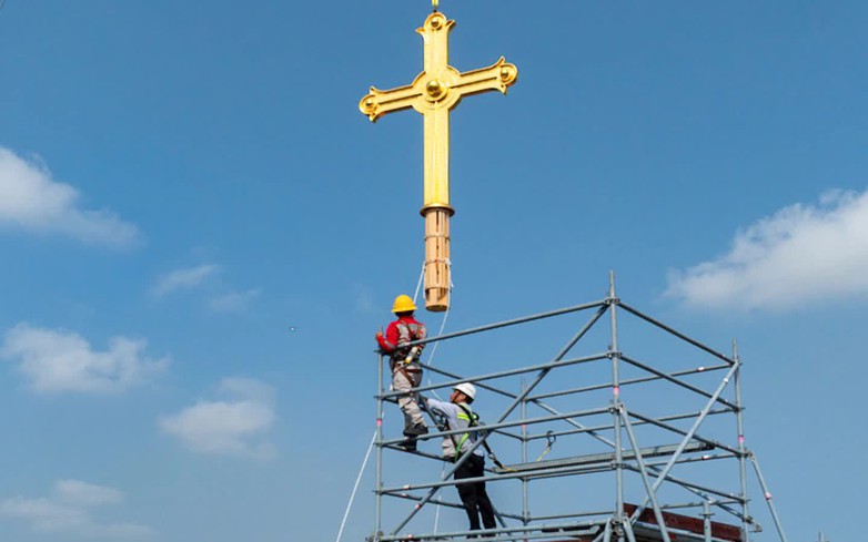 Gold-plated crosses return to Notre-Dame Cathedral towers in Ho Chi Minh City